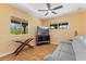 Bright living room featuring a ceiling fan, natural light, and comfortable seating at 4730 Cypress Creek Ranch Rd, St Cloud, FL 34771