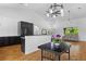 Open-concept living room features a modern kitchen, stylish dining area, and a cozy seating area with ample natural light at 4730 Cypress Creek Ranch Rd, St Cloud, FL 34771