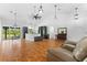Open-concept living space featuring hardwood floors, a high ceiling, and a seamless flow to the adjacent kitchen area at 4730 Cypress Creek Ranch Rd, St Cloud, FL 34771