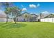 Expansive backyard with green lawn and a modern home, perfect for relaxation and entertaining at 501 Dunoon St, Ocoee, FL 34761