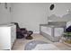 Warm bedroom, with a brown leather chair and ottoman, and neutral colored walls at 501 Dunoon St, Ocoee, FL 34761