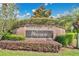 Well-manicured Wesmere community entrance with brick sign and lush landscaping under a sunny blue sky at 501 Dunoon St, Ocoee, FL 34761