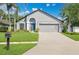 Charming home featuring a well-manicured lawn, attached garage, and inviting front entrance at 501 Dunoon St, Ocoee, FL 34761