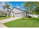 Lovely home with a well-maintained lawn, mature trees, and a convenient two-car garage at 501 Dunoon St, Ocoee, FL 34761