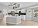 Well-lit kitchen with a central island, stainless steel appliances, and modern finishes at 501 Dunoon St, Ocoee, FL 34761