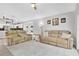 Spacious living room featuring two sofas, neutral walls and tile floors with views to the kitchen at 501 Dunoon St, Ocoee, FL 34761