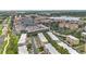 Beautiful aerial view of the complex, showcasing multiple buildings, parking garage, and nearby lake at 5038 Tideview Cir # 21, Orlando, FL 32819