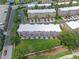 Aerial view highlighting townhomes with green spaces, parking, and surrounding streets at 5038 Tideview Cir # 21, Orlando, FL 32819