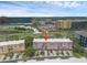 Aerial view of townhomes with colorful exteriors, surrounded by palm trees, and city views at 5038 Tideview Cir # 21, Orlando, FL 32819