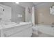 Bright bathroom featuring a white vanity, sink, and a bathtub-shower combination with a white shower curtain at 5038 Tideview Cir # 21, Orlando, FL 32819
