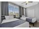 Bright bedroom featuring two beds, a ceiling fan, and a double door closet at 5038 Tideview Cir # 21, Orlando, FL 32819