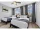 Bedroom with two twin beds, a ceiling fan, and a window with natural light at 5038 Tideview Cir # 21, Orlando, FL 32819