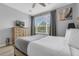 Bedroom featuring a large window, a dresser with a TV, and gray curtains at 5038 Tideview Cir # 21, Orlando, FL 32819