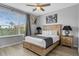 Bedroom with a large window, two nightstands, and modern art at 5038 Tideview Cir # 21, Orlando, FL 32819