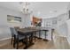 Dining area with modern table and chairs, chandelier, and bar seating, seamlessly flowing into the kitchen at 5038 Tideview Cir # 21, Orlando, FL 32819