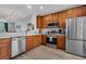 Well-equipped kitchen featuring stainless steel appliances, wood cabinetry, and a breakfast bar overlooking dining area at 5038 Tideview Cir # 21, Orlando, FL 32819
