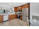 Bright kitchen featuring stainless steel appliances, wood cabinets, and a glass breakfast table at 5038 Tideview Cir # 21, Orlando, FL 32819