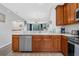 Well-equipped kitchen featuring stainless steel appliances, wood cabinetry, and a view to the open concept living area at 5038 Tideview Cir # 21, Orlando, FL 32819