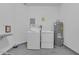 Laundry room equipped with washing machine, dryer, and hot water tank at 5038 Tideview Cir # 21, Orlando, FL 32819