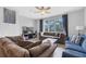 Open living room featuring a comfortable sectional sofa, a mounted TV, and sliding glass doors to a balcony at 5038 Tideview Cir # 21, Orlando, FL 32819