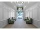Bright lobby with high ceilings, tiled floor, decorative wainscoting, and comfortable seating areas at 5038 Tideview Cir # 21, Orlando, FL 32819