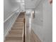 Hallway view featuring a wood staircase and wainscoting leading up to the next level at 5038 Tideview Cir # 21, Orlando, FL 32819