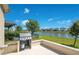 Backyard featuring a barbecue and serene lake view at 5133 Chickadee St, St Cloud, FL 34771