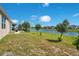 Lush backyard showcasing a tranquil lake view at 5133 Chickadee St, St Cloud, FL 34771