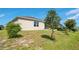 Exterior view of home with landscaped backyard and lawn at 5133 Chickadee St, St Cloud, FL 34771