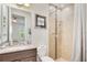 Bright bathroom with a vanity, granite countertop, toilet and a tiled shower at 5133 Chickadee St, St Cloud, FL 34771