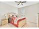 Well-lit bedroom offers soft carpeting, a ceiling fan, and neutral paint at 5133 Chickadee St, St Cloud, FL 34771