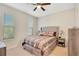 Well-lit bedroom showcasing soft carpeting, side tables and neutral paint at 5133 Chickadee St, St Cloud, FL 34771