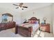 Well-lit bedroom boasts a ceiling fan, side tables, dresser and a spacious interior at 5133 Chickadee St, St Cloud, FL 34771