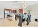 Open kitchen and dining area featuring a large island, pendant lighting, stainless steel appliances, and modern chandelier at 5133 Chickadee St, St Cloud, FL 34771