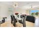 Stylish dining area adjacent to the living room features a modern chandelier and view of the lake at 5133 Chickadee St, St Cloud, FL 34771