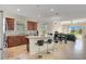 Open kitchen with granite countertops, stainless steel appliances, breakfast bar, and seamless flow to the dining area at 5133 Chickadee St, St Cloud, FL 34771