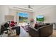 Bright living room with tile floors, a ceiling fan, and a view of the lake through sliding glass doors at 5133 Chickadee St, St Cloud, FL 34771