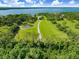 Lush acreage leads to a pond and expansive lake views at 5150 Gentry Oaks Pl, St Cloud, FL 34772