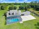 Aerial view of the home showcasing the pool, back of the house and extended driveway at 5150 Gentry Oaks Pl, St Cloud, FL 34772