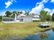 Exterior home featuring an in-ground pool, oversized garage, dock and landscaping at 5150 Gentry Oaks Pl, St Cloud, FL 34772