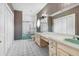 Bathroom with a blue bathtub, striped wallpaper, and a double vanity at 5150 Gentry Oaks Pl, St Cloud, FL 34772