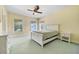 Bedroom with two large windows, ceiling fan, and a floral wallpaper design at 5150 Gentry Oaks Pl, St Cloud, FL 34772
