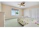 Bright bedroom with two twin beds, ceiling fan, and two closets at 5150 Gentry Oaks Pl, St Cloud, FL 34772