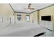 Spacious bedroom featuring a bed, dresser with TV, and three windows at 5150 Gentry Oaks Pl, St Cloud, FL 34772