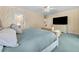 Bedroom with floral wallpaper, large bed, and dresser with television at 5150 Gentry Oaks Pl, St Cloud, FL 34772