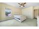 Bedroom with a bed, two closets, and a window that provides natural light at 5150 Gentry Oaks Pl, St Cloud, FL 34772