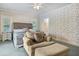 Cozy bedroom with sitting area, floral wallpaper, and tufted headboard at 5150 Gentry Oaks Pl, St Cloud, FL 34772