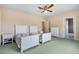 Bedroom with two twin beds, ceiling fan, and two closets at 5150 Gentry Oaks Pl, St Cloud, FL 34772