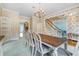 Formal dining room with an elegant chandelier, carpet, and wallpaper at 5150 Gentry Oaks Pl, St Cloud, FL 34772