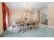 Formal dining room with chandelier, carpet, and wallpaper at 5150 Gentry Oaks Pl, St Cloud, FL 34772